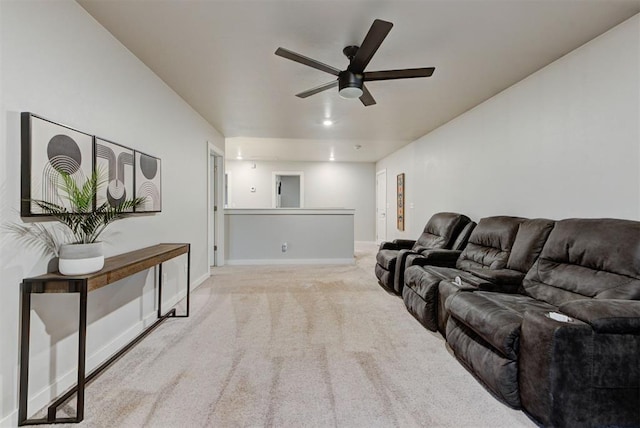 living area with carpet flooring, ceiling fan, and baseboards