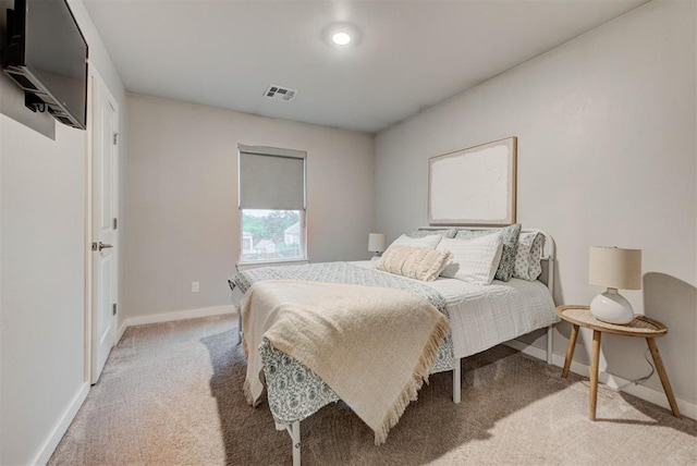 carpeted bedroom featuring baseboards and visible vents