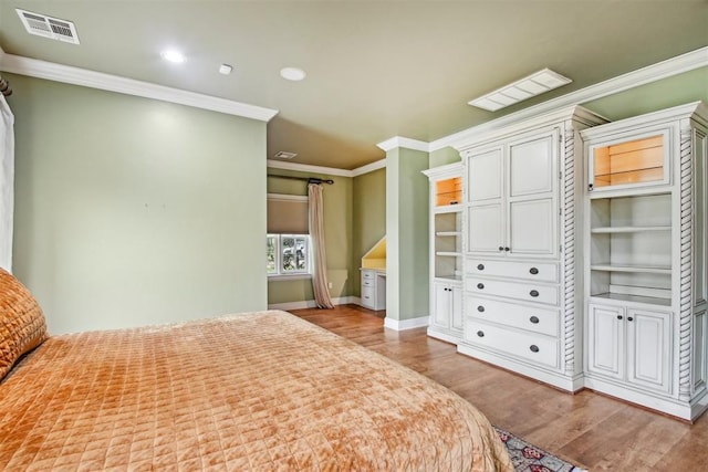 unfurnished bedroom with visible vents, wood finished floors, baseboards, ornamental molding, and recessed lighting