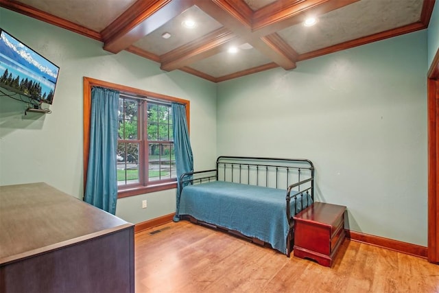 bedroom with baseboards, ornamental molding, light wood finished floors, and beamed ceiling