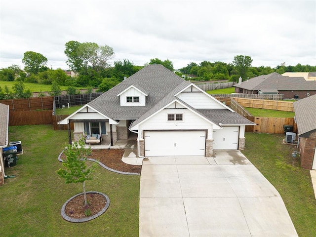 craftsman inspired home with roof with shingles, an attached garage, driveway, and a front lawn