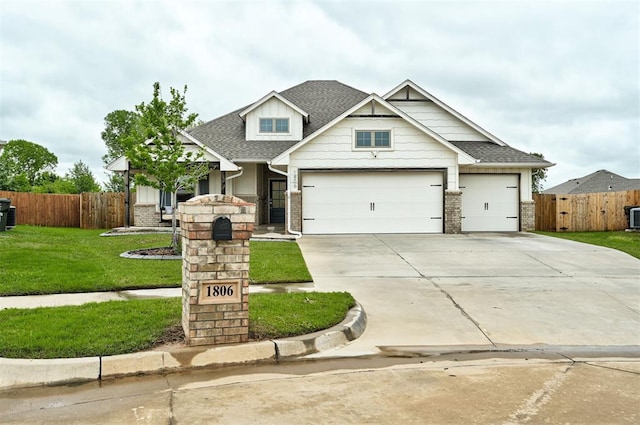 craftsman-style house with a garage, a front lawn, fence, roof with shingles, and driveway