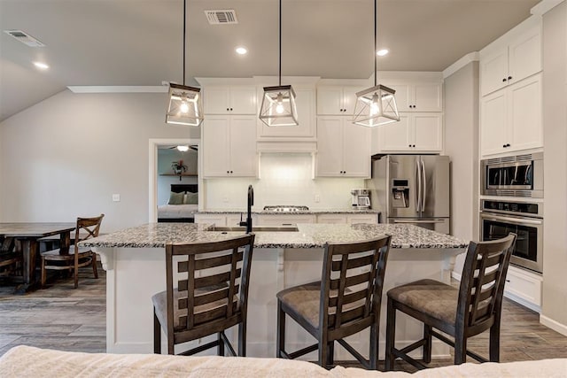 kitchen featuring a sink, appliances with stainless steel finishes, dark wood finished floors, and visible vents