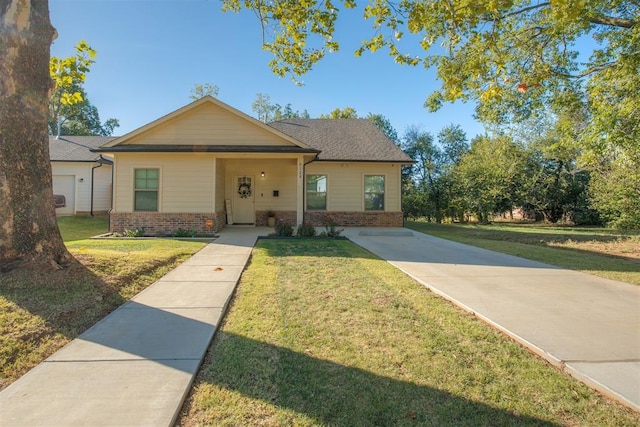 bungalow-style house with a front yard and brick siding