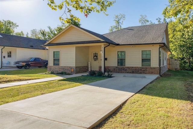 view of front of property with brick siding and a front yard