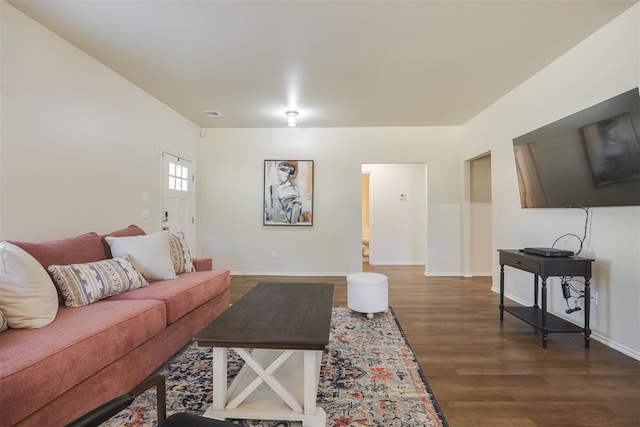 living room featuring baseboards and dark wood-style flooring