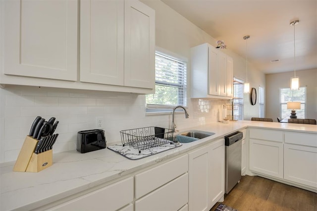kitchen with dark wood-type flooring, white cabinetry, a sink, dishwasher, and hanging light fixtures