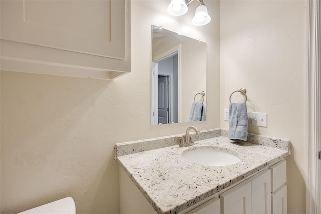 half bath with vanity and toilet