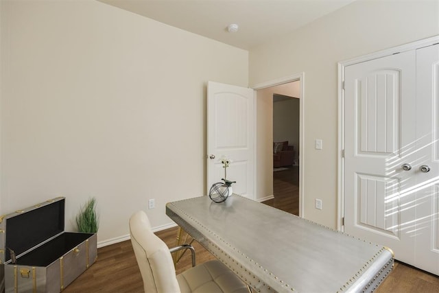 home office with dark wood-type flooring
