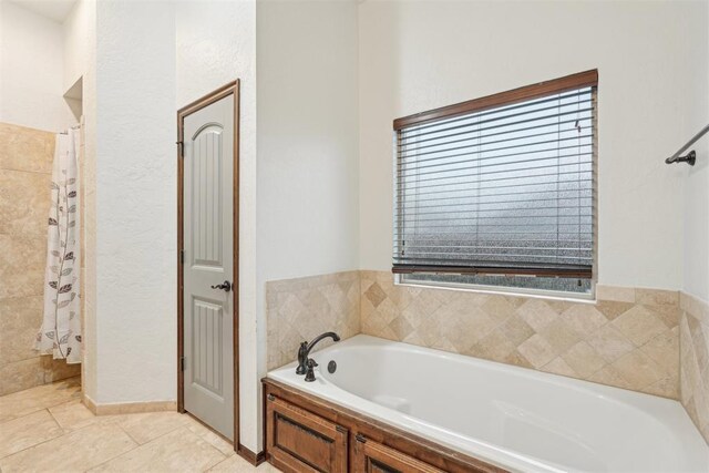 full bathroom with tile patterned floors, a bath, and a shower with shower curtain
