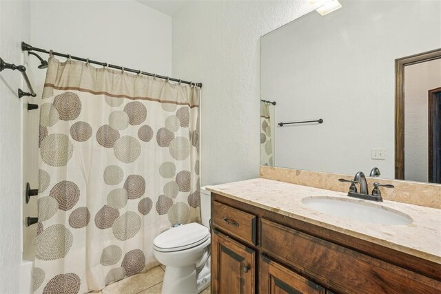 full bath featuring vanity, tile patterned flooring, toilet, and curtained shower