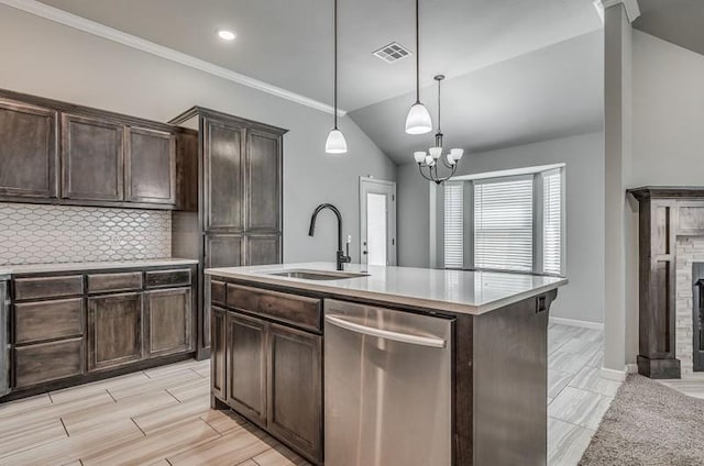 kitchen with stainless steel dishwasher, visible vents, dark brown cabinets, light countertops, and a sink