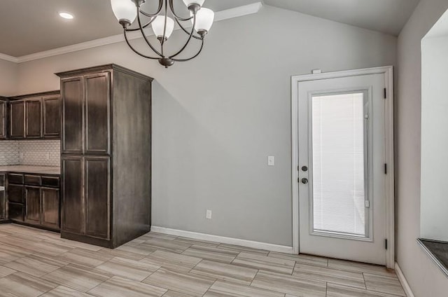 unfurnished dining area featuring crown molding, a chandelier, recessed lighting, baseboards, and wood tiled floor