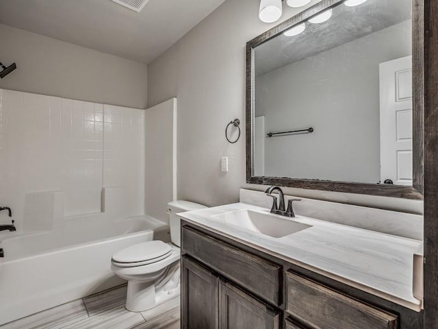 bathroom with toilet, shower / tub combination, and vanity