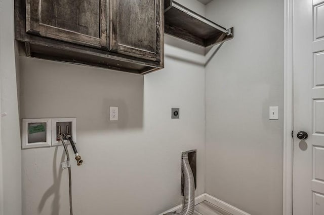laundry area with washer hookup, hookup for an electric dryer, baseboards, and cabinet space