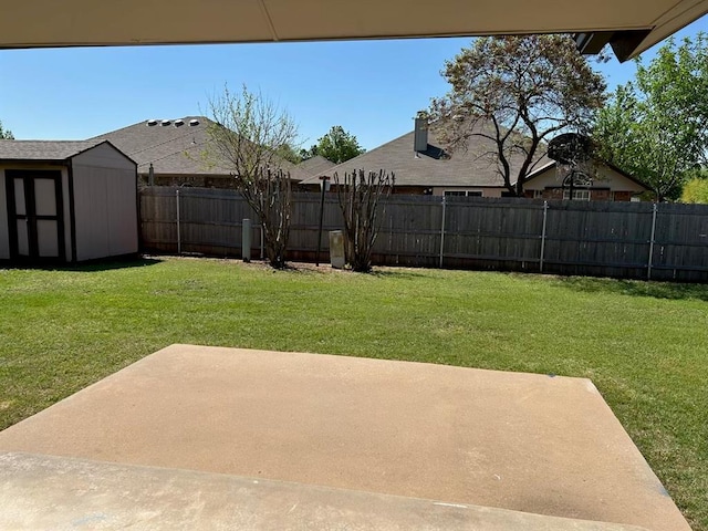 view of yard with a fenced backyard, an outbuilding, a patio area, and a shed