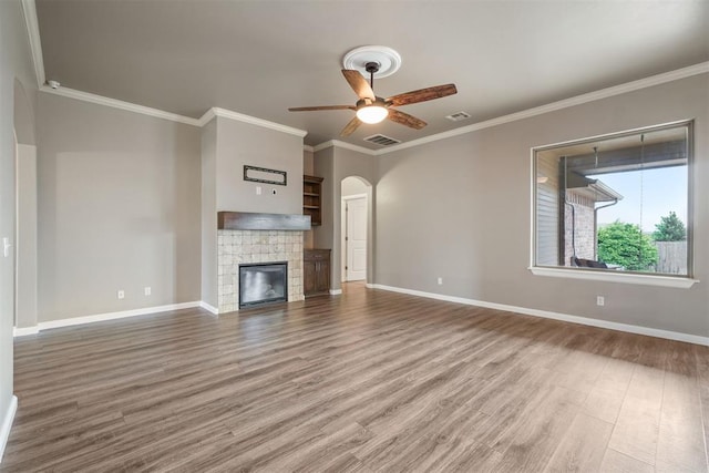 unfurnished living room with visible vents, a ceiling fan, baseboards, and wood finished floors