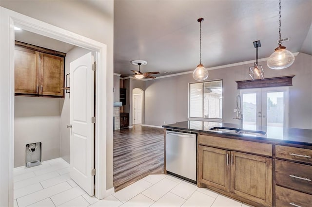 kitchen with ceiling fan, french doors, hanging light fixtures, stainless steel dishwasher, and a sink