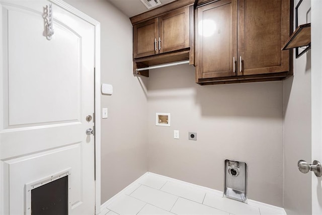 laundry room with light tile patterned flooring, baseboards, hookup for a washing machine, electric dryer hookup, and cabinet space