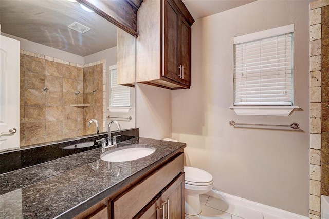 bathroom featuring visible vents, tile patterned flooring, vanity, toilet, and tiled shower