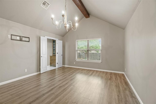 unfurnished bedroom featuring an inviting chandelier, baseboards, and wood finished floors