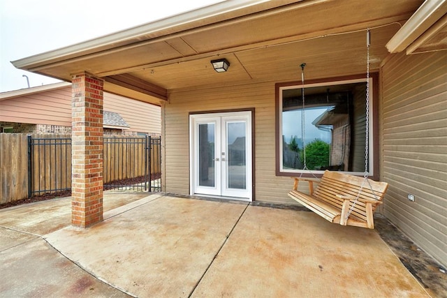 view of patio / terrace with french doors and fence