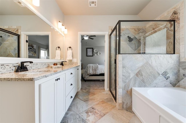 ensuite bathroom with a shower stall, a garden tub, a ceiling fan, and double vanity
