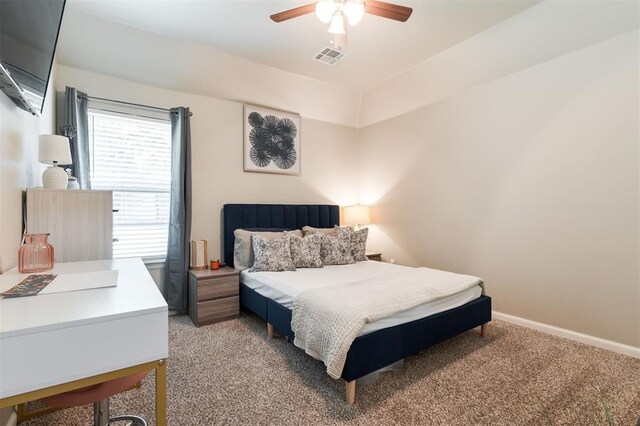 bedroom with light colored carpet, a ceiling fan, and baseboards