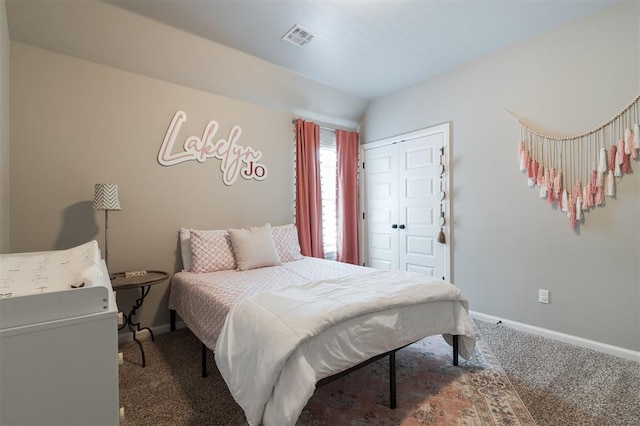 bedroom featuring carpet flooring, a closet, baseboards, and vaulted ceiling