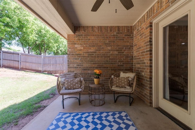 view of patio / terrace with a ceiling fan and fence