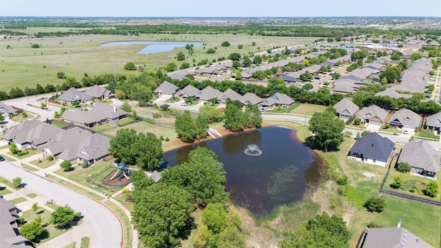 aerial view of property's location featuring a large body of water and nearby suburban area