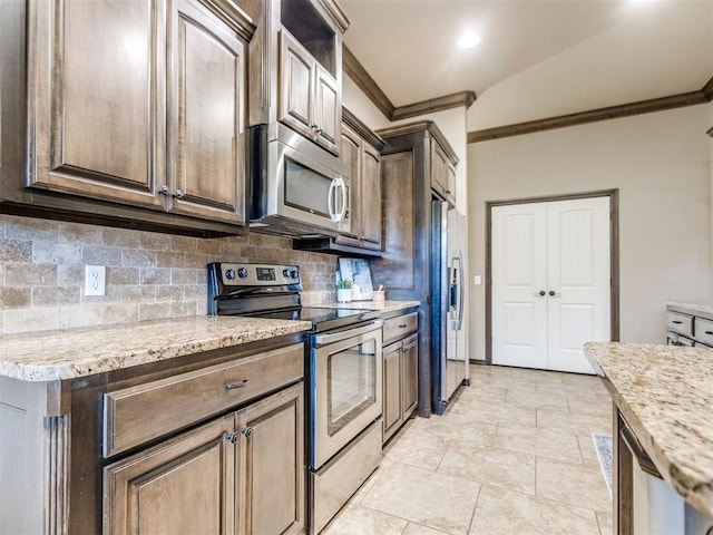 kitchen featuring ornamental molding, tasteful backsplash, and stainless steel appliances