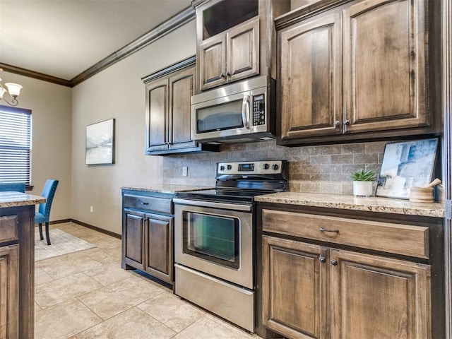 kitchen with light stone counters, stainless steel appliances, baseboards, tasteful backsplash, and ornamental molding