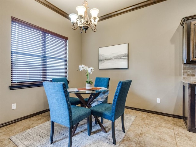 dining room with crown molding, baseboards, and a notable chandelier