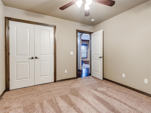 unfurnished bedroom with baseboards, a closet, light carpet, and ceiling fan
