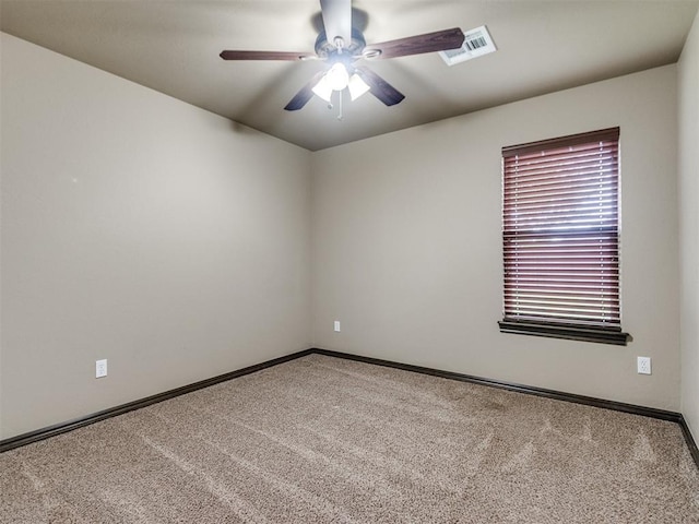 carpeted spare room with a ceiling fan, baseboards, and visible vents