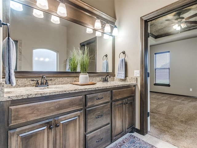 full bathroom featuring a sink, tile patterned flooring, ceiling fan, and double vanity