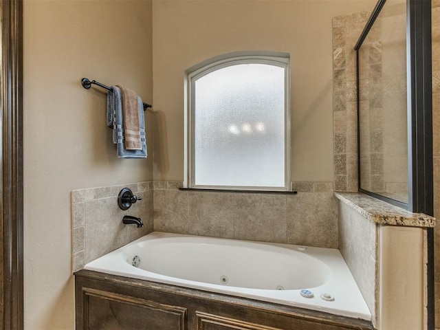 full bath featuring a wealth of natural light and a jetted tub