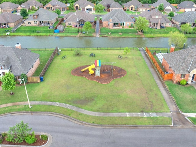 birds eye view of property with a water view and a residential view