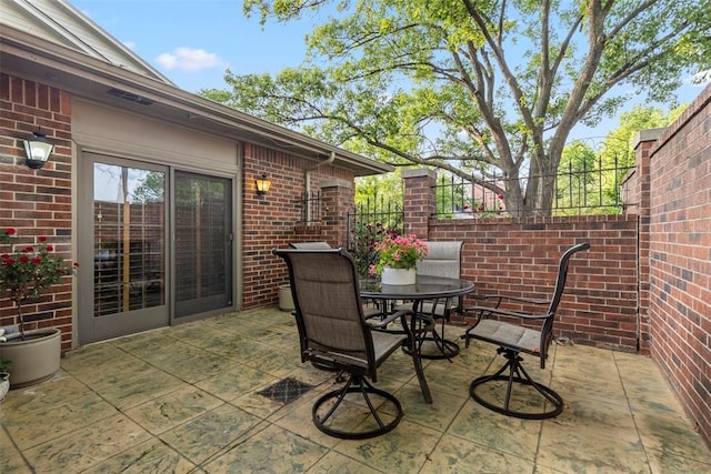 view of patio / terrace featuring fence and outdoor dining space