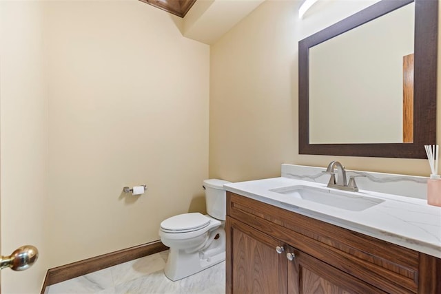 half bathroom featuring vanity and toilet
