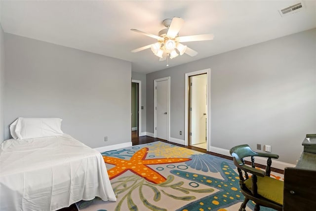 bedroom featuring baseboards, a ceiling fan, and visible vents