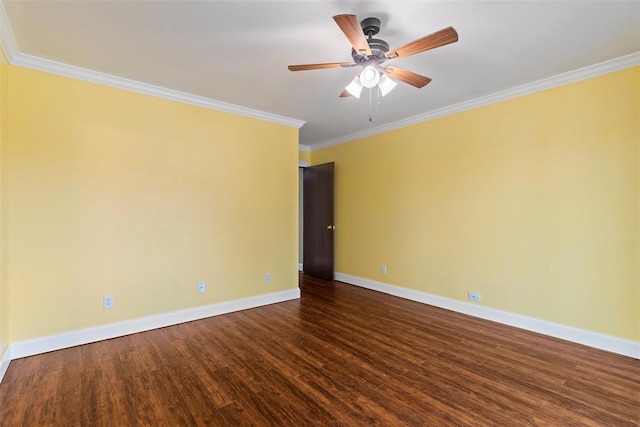 spare room with baseboards, ornamental molding, dark wood-style flooring, and ceiling fan