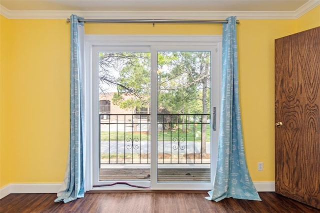 doorway to outside with crown molding, baseboards, and plenty of natural light
