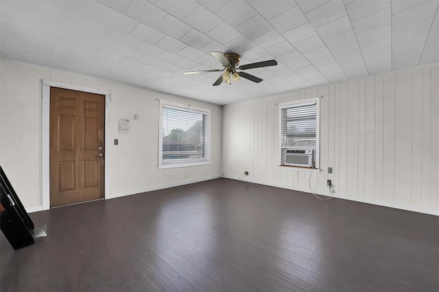 interior space featuring baseboards, ceiling fan, and wood finished floors