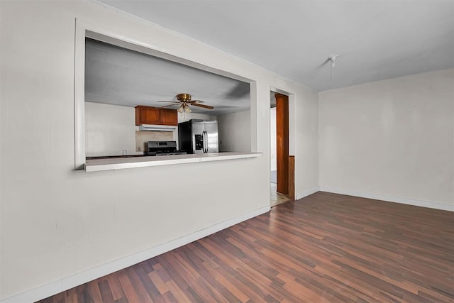 unfurnished living room featuring baseboards, ceiling fan, and wood finished floors