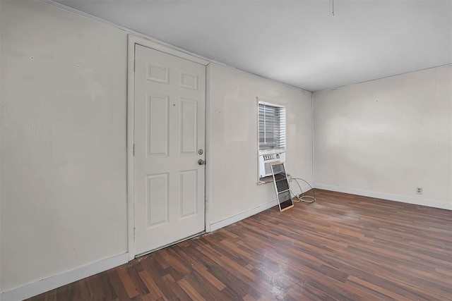 unfurnished room featuring baseboards and wood finished floors
