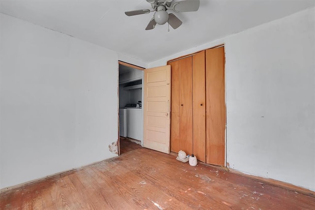 unfurnished bedroom featuring washer / clothes dryer, ceiling fan, and light wood-style floors