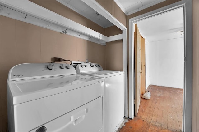 clothes washing area featuring laundry area, washer and clothes dryer, and light wood-style floors