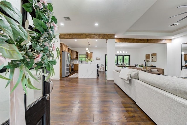 living area with recessed lighting, visible vents, dark wood-style floors, and an inviting chandelier